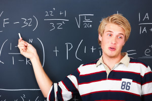 Education - Young man demonstrating algebra